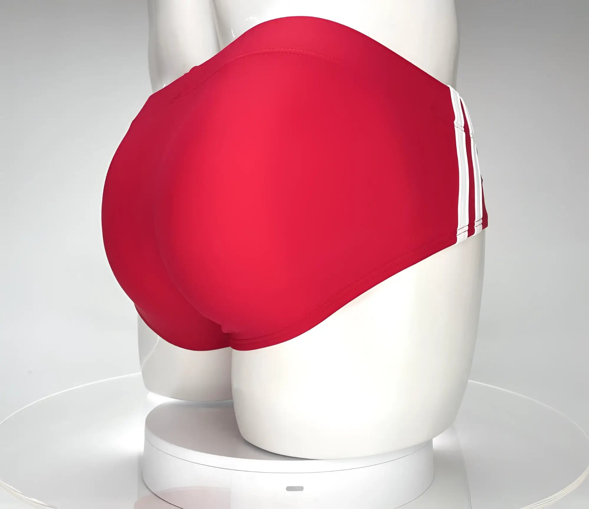 Red swim briefs WildmanT Monster Cock with three white side stripes displayed on a mannequin front view