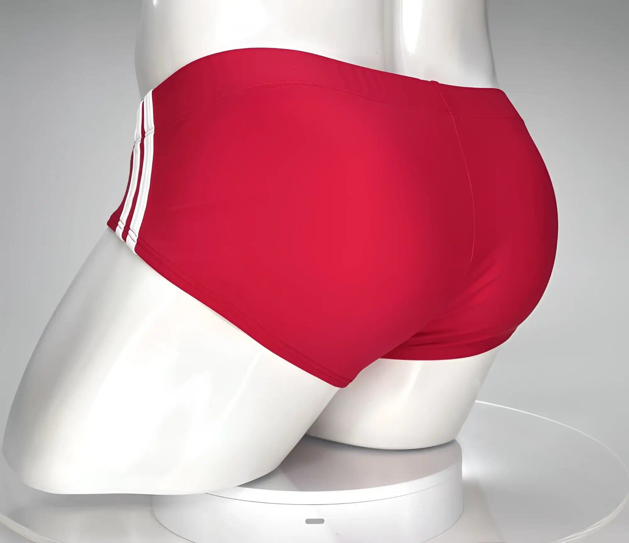 Wildmant monster cock swim brief red swim trunks with three white stripes on the side displayed on a mannequin