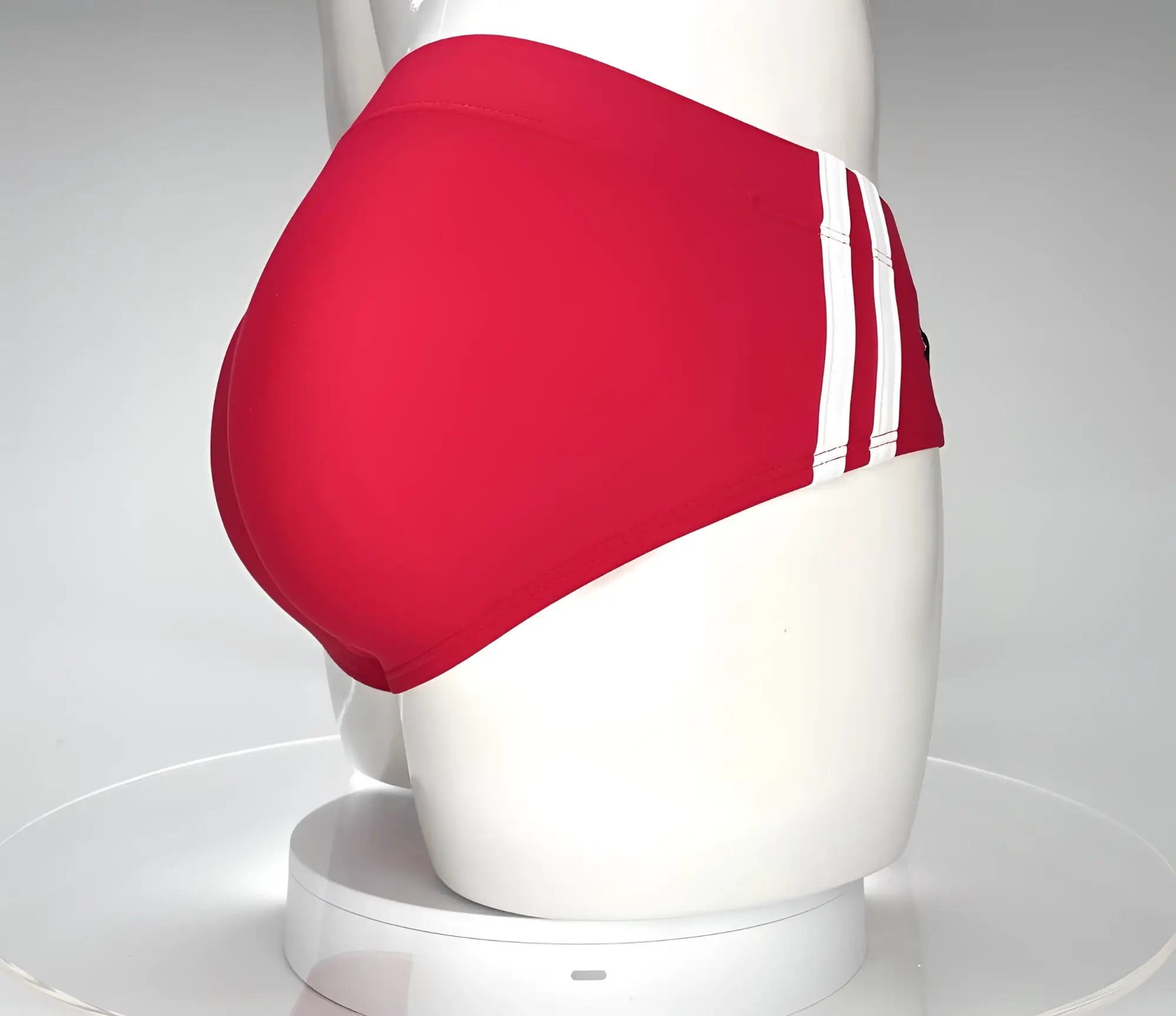 Wildmant monster cock swim brief red swim trunks with three white stripes on the side displayed on a mannequin