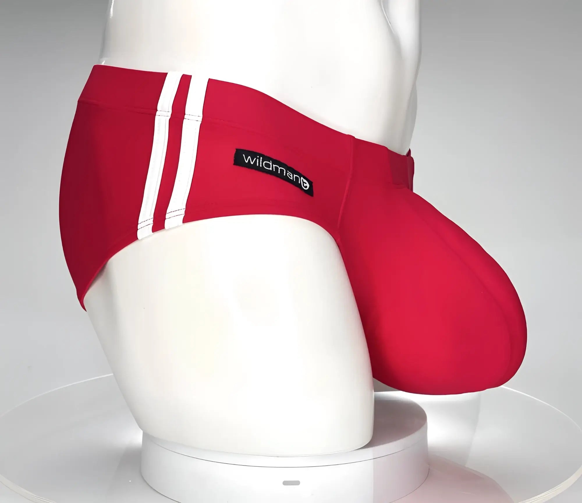 Red wildmanT monster cock swim brief with white side stripes and black brand label, designed for swimming use