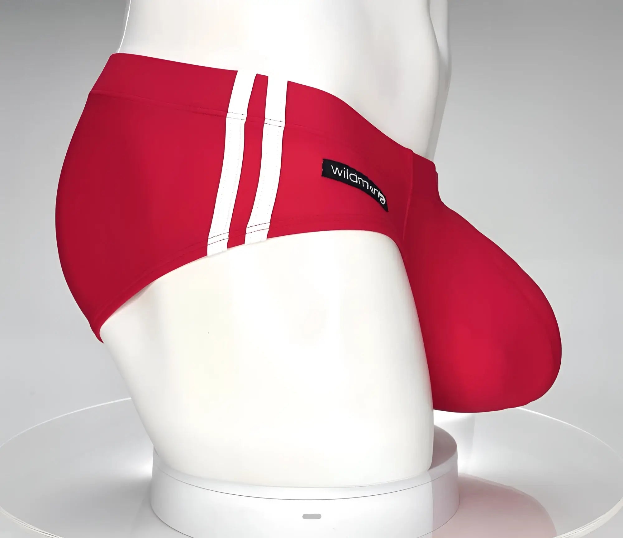 Wildmant monster cock swim brief red featuring red swim trunks with white vertical stripes and black wildmango label