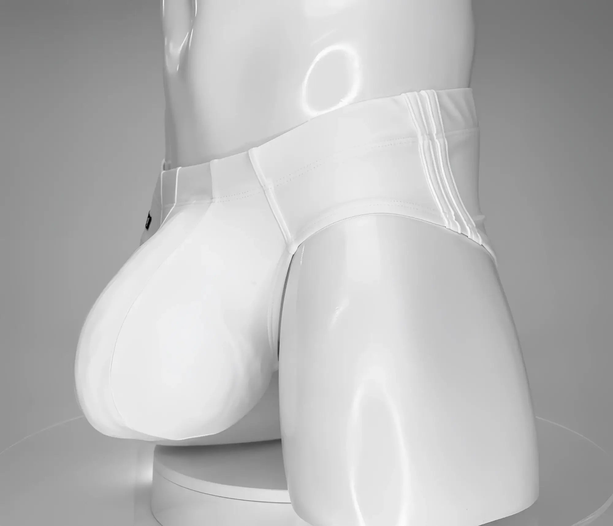 WildmanT monster cock swim brief in white glossy latex with smooth shiny surface and subtle vertical seam detailing