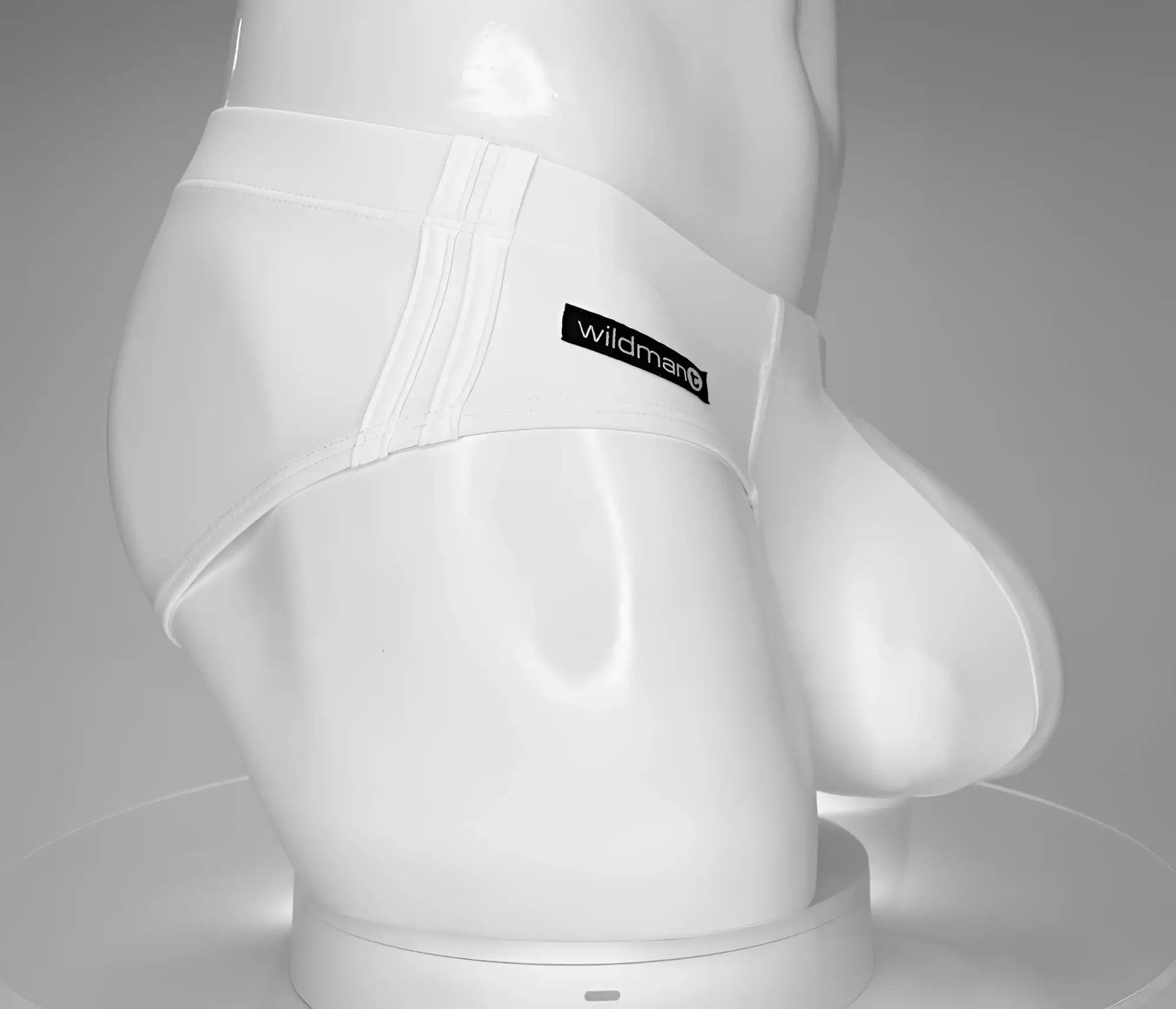 White Wildman brand men’s briefs with smooth, form-fitting design and visible seam detailing in WildmanT Monster Cock swim brief