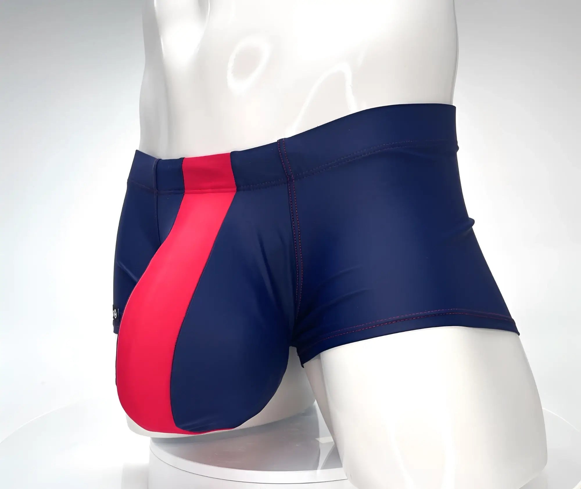 Navy blue WildmanT Monster Cock swim square cut trunks with a bold red diagonal stripe for swimming