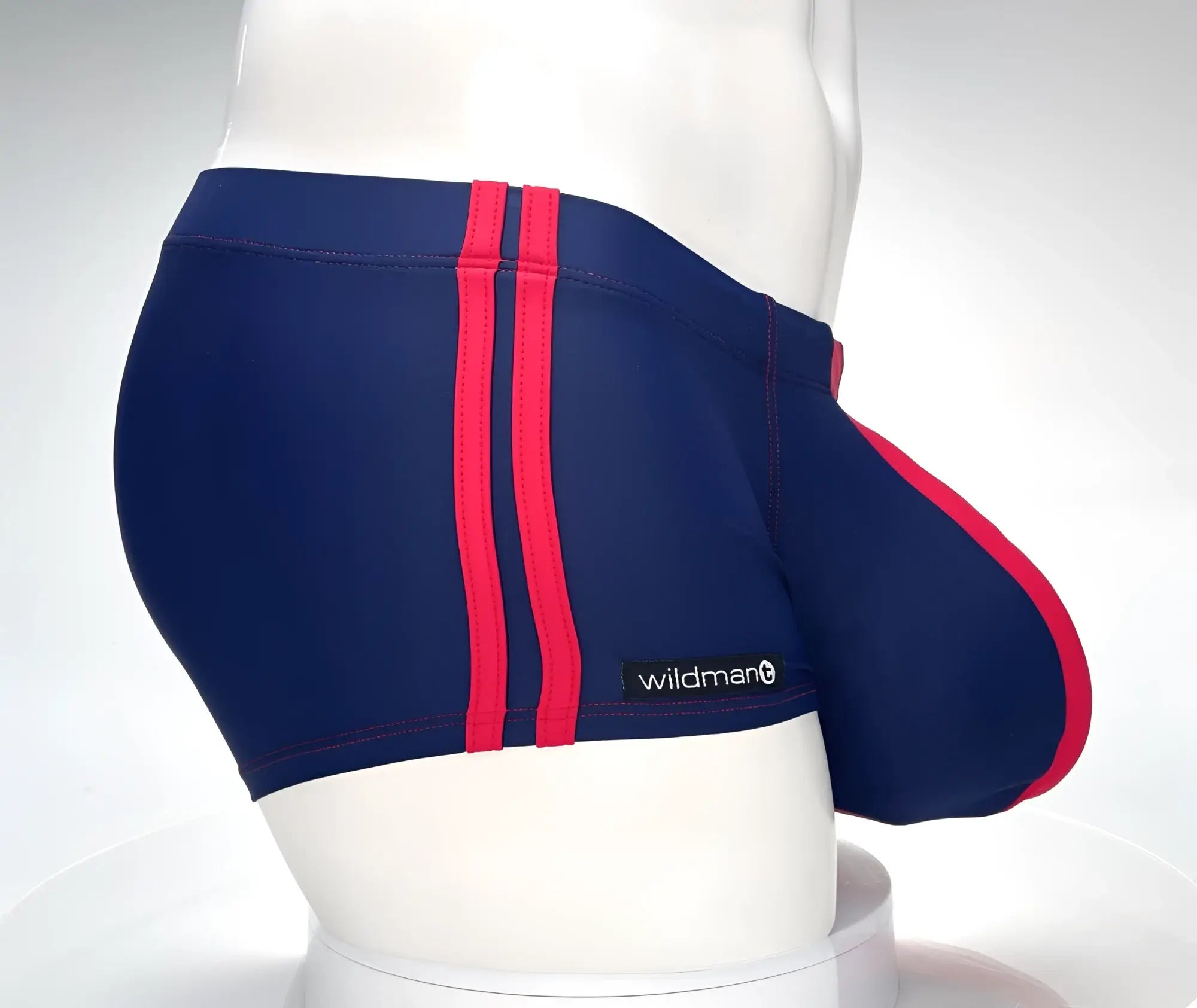 Navy blue WildmanT Monster Cock swim square cut trunks with bold red stripes and a Wildman brand label