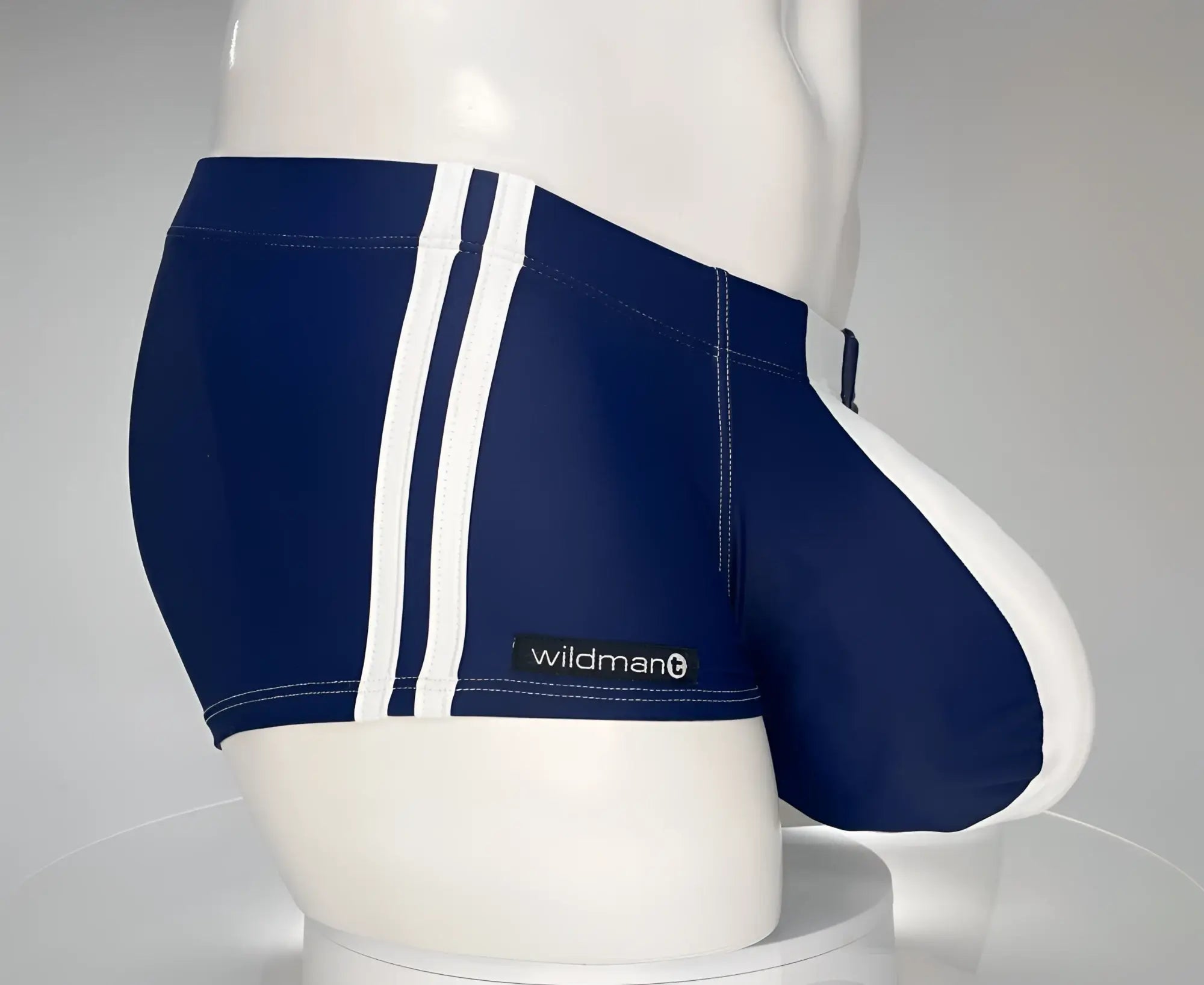 WildmanT monster cock swim square cut navy blue swim trunks with white side stripes and wildman brand label