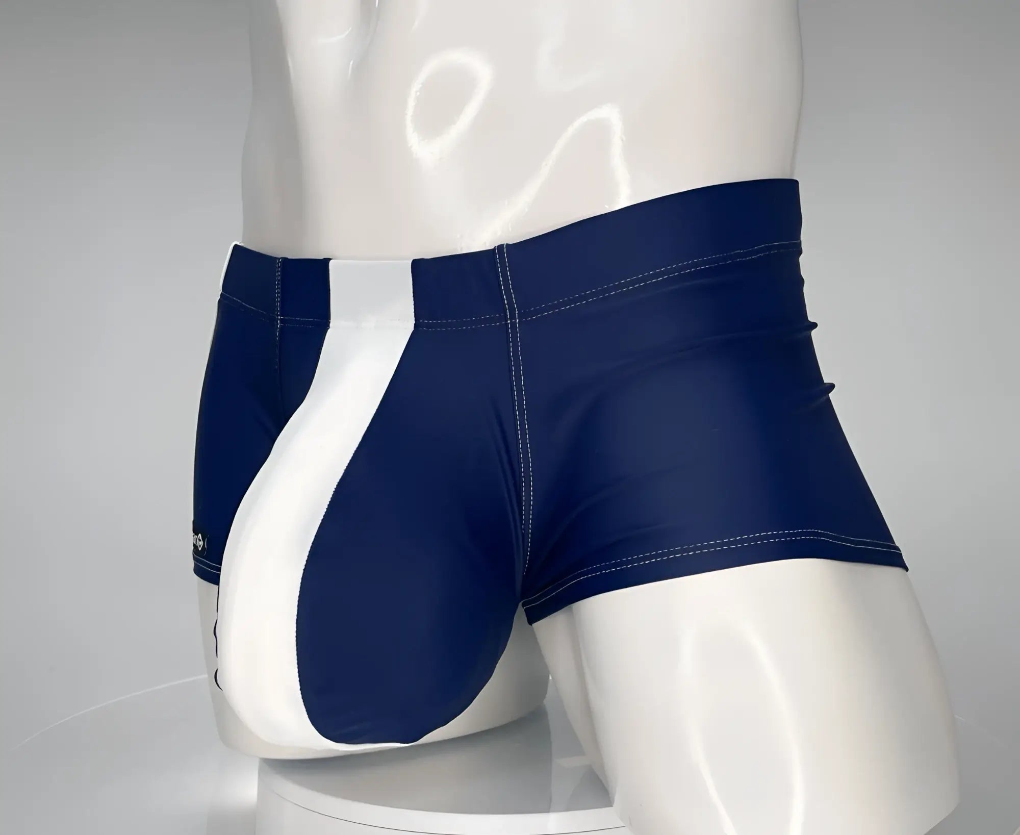 Navy blue and white WildmanT Monster Cock sleek form-fitting swim trunks with a square cut design