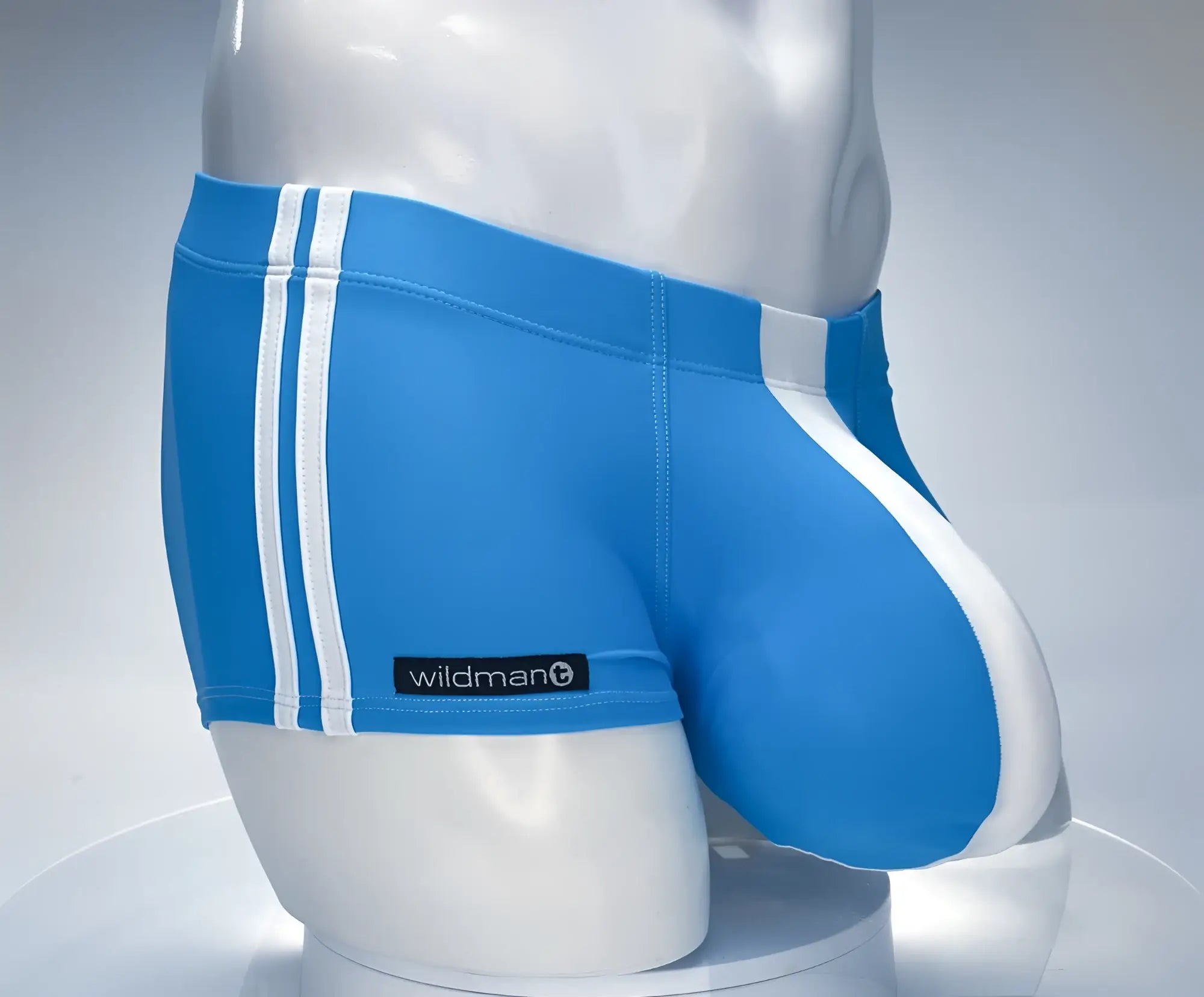 Blue wildman swim square cut trunks with white stripes featuring a monster cock design in teal and white