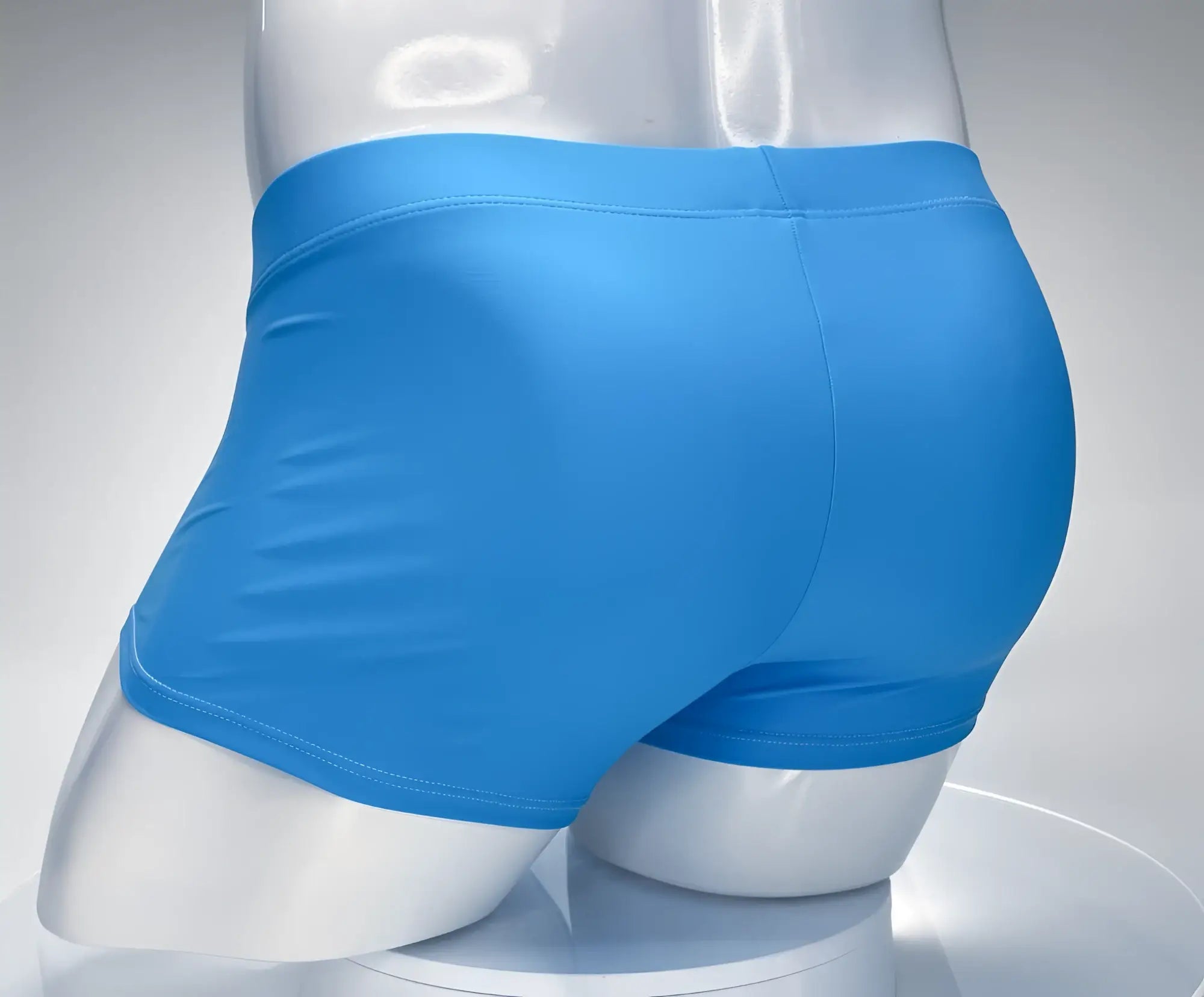 Bright blue smooth finish men’s boxer briefs WildmanT Monster Cock Swim Square Cut in teal and white on a mannequin