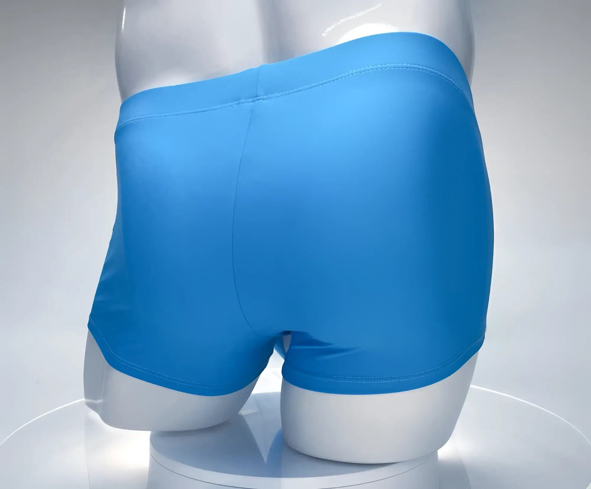 Bright blue smooth textured men’s boxer briefs wildmant monster cock swim square cut in teal and white on mannequin
