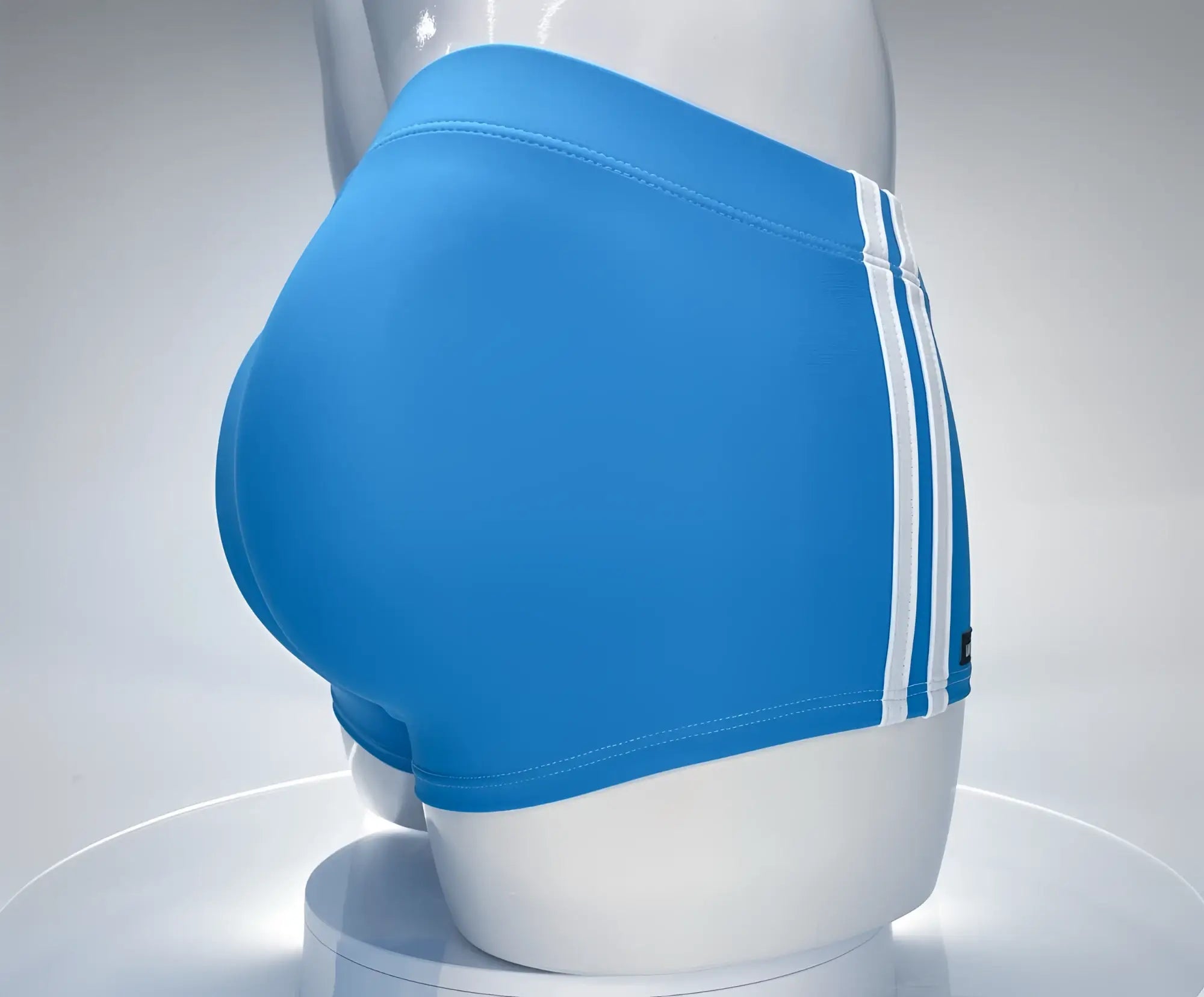 Bright blue wildmant monster cock swim square cut trunks with three white stripes displayed on a mannequin