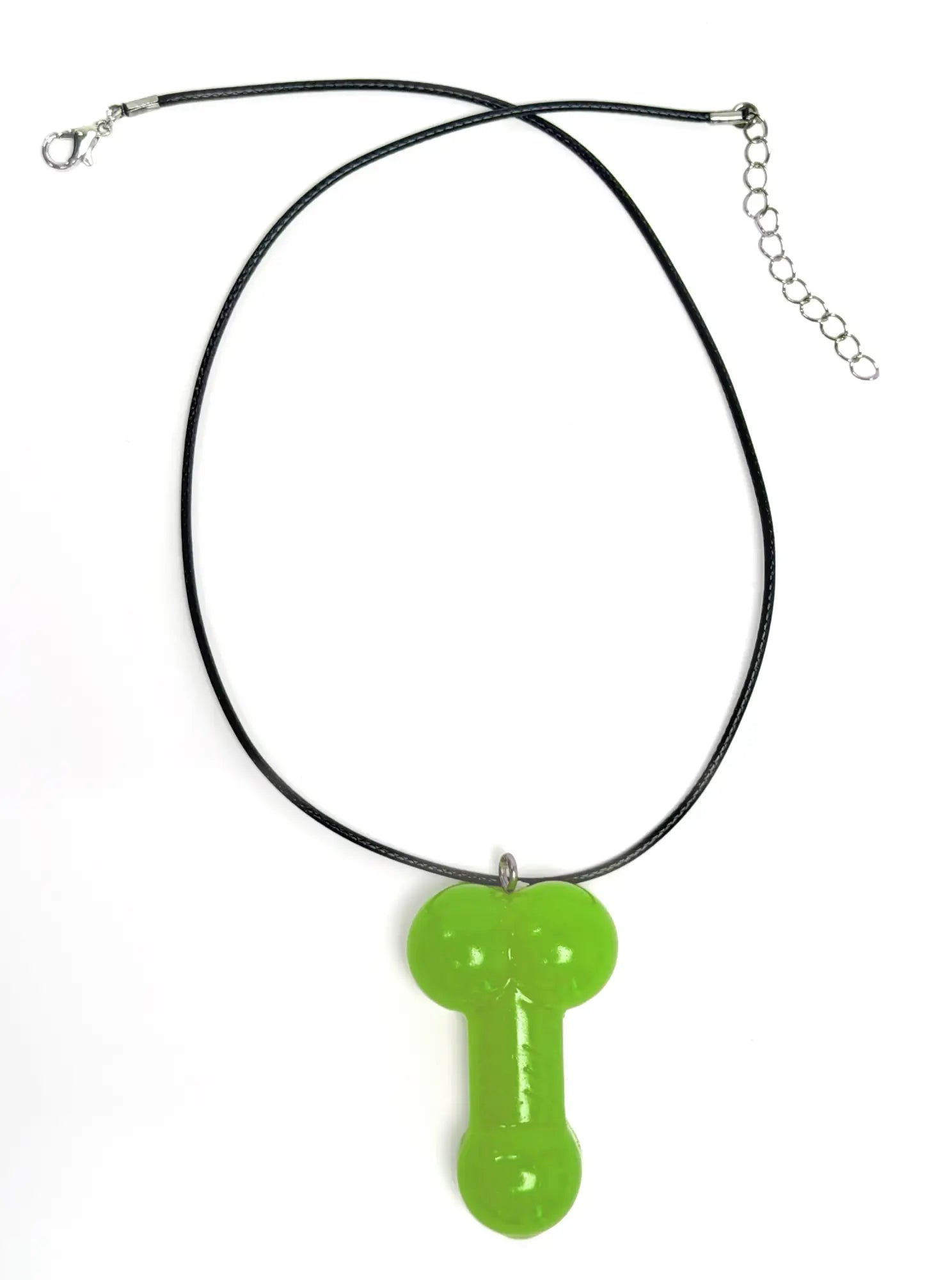 Front view of a WildmanT penis-shaped pendant in neon green, hanging on a black cord necklace.