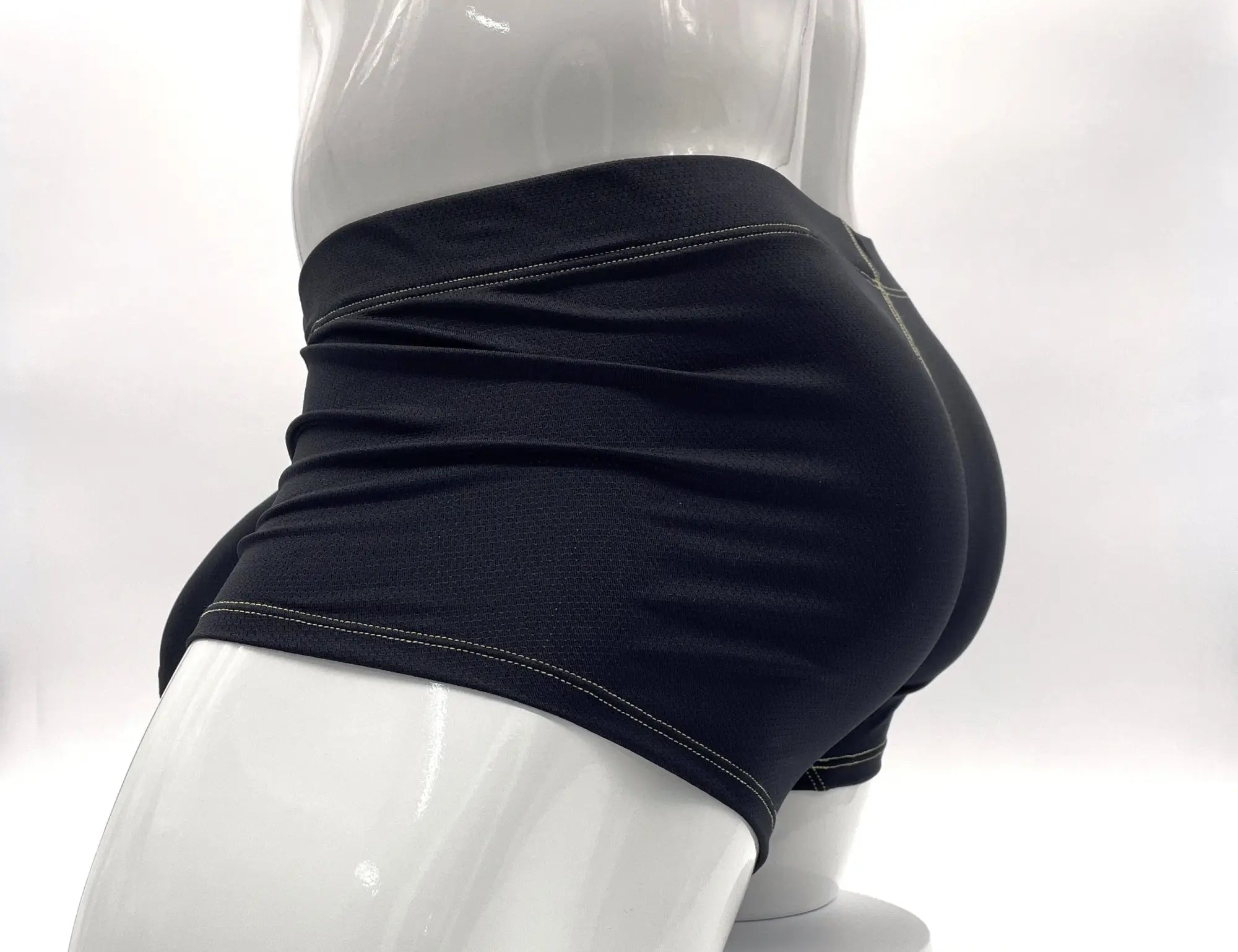 Black athletic shorts with white stitching along the waistband and hem.