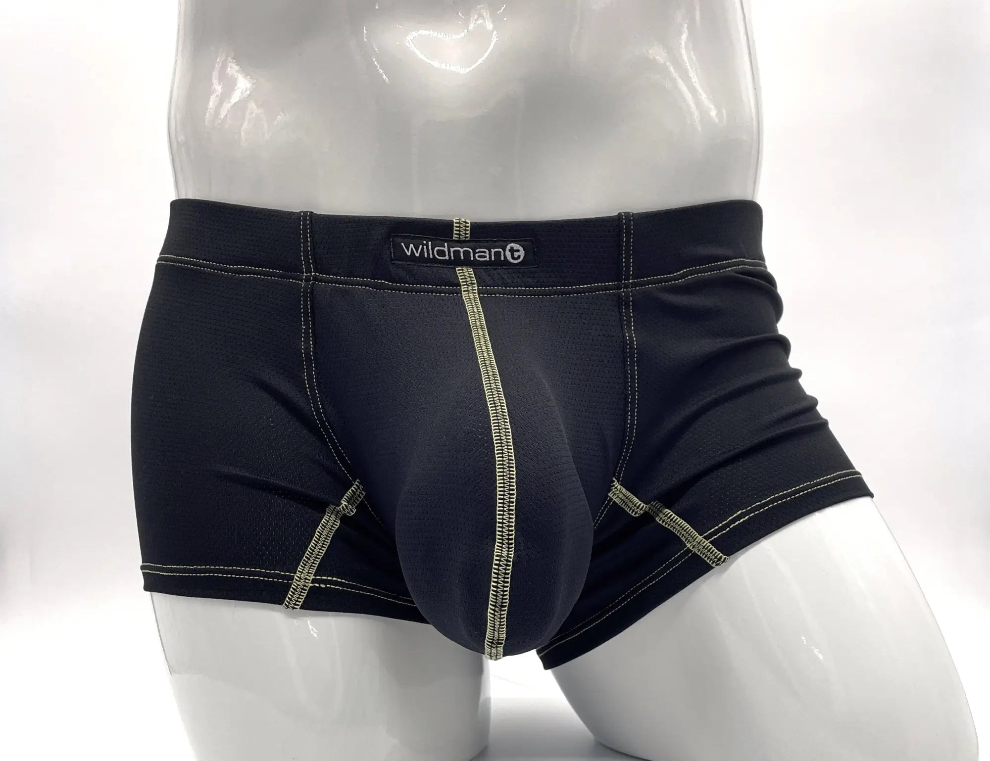 Black wildman brand men’s boxer briefs with contrasting light green stitching and a supportive, contoured design.