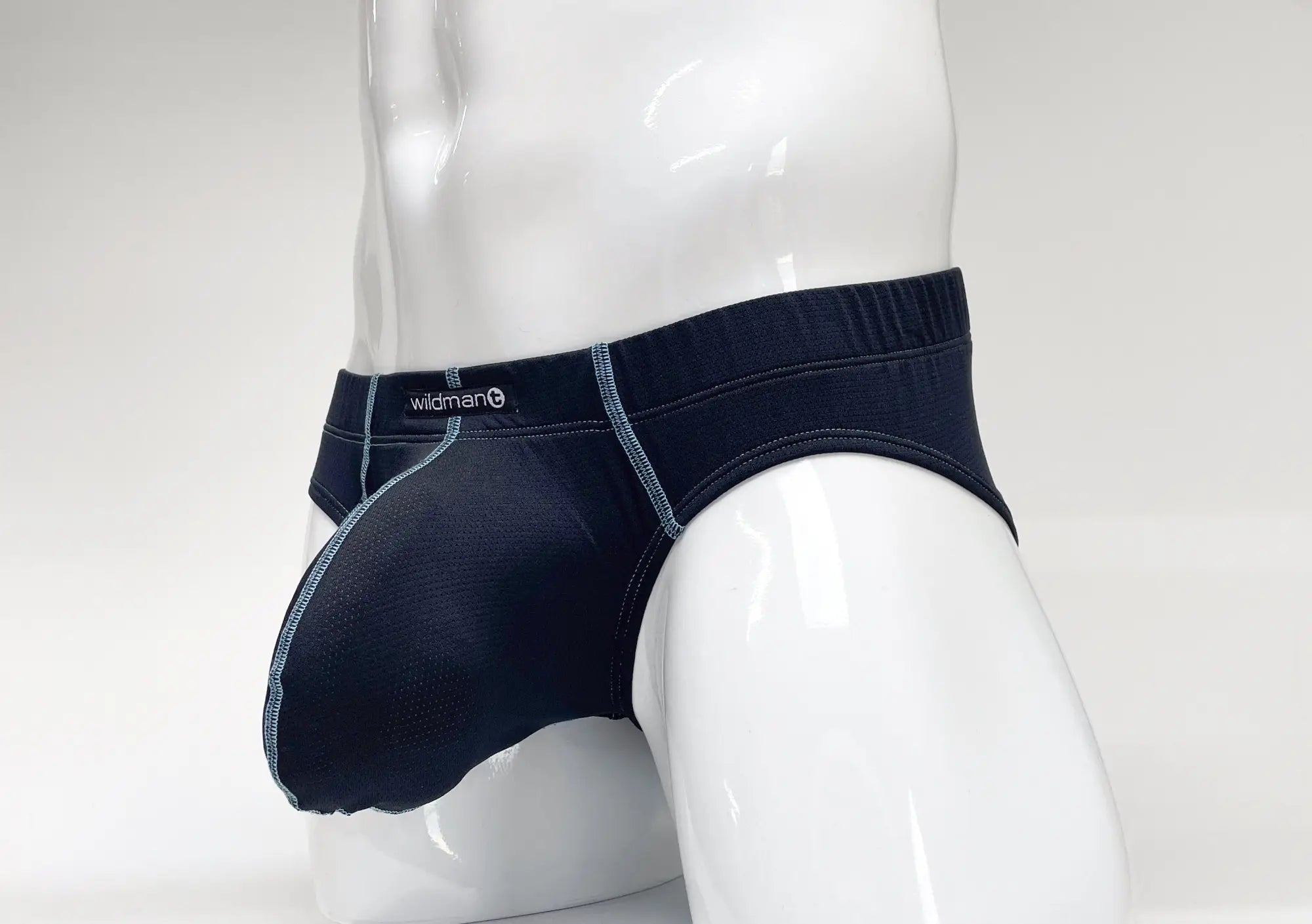 Dark blue denim briefs with light gray stitching and wildman logo on waistband wildmant stitch big boy pouch brief