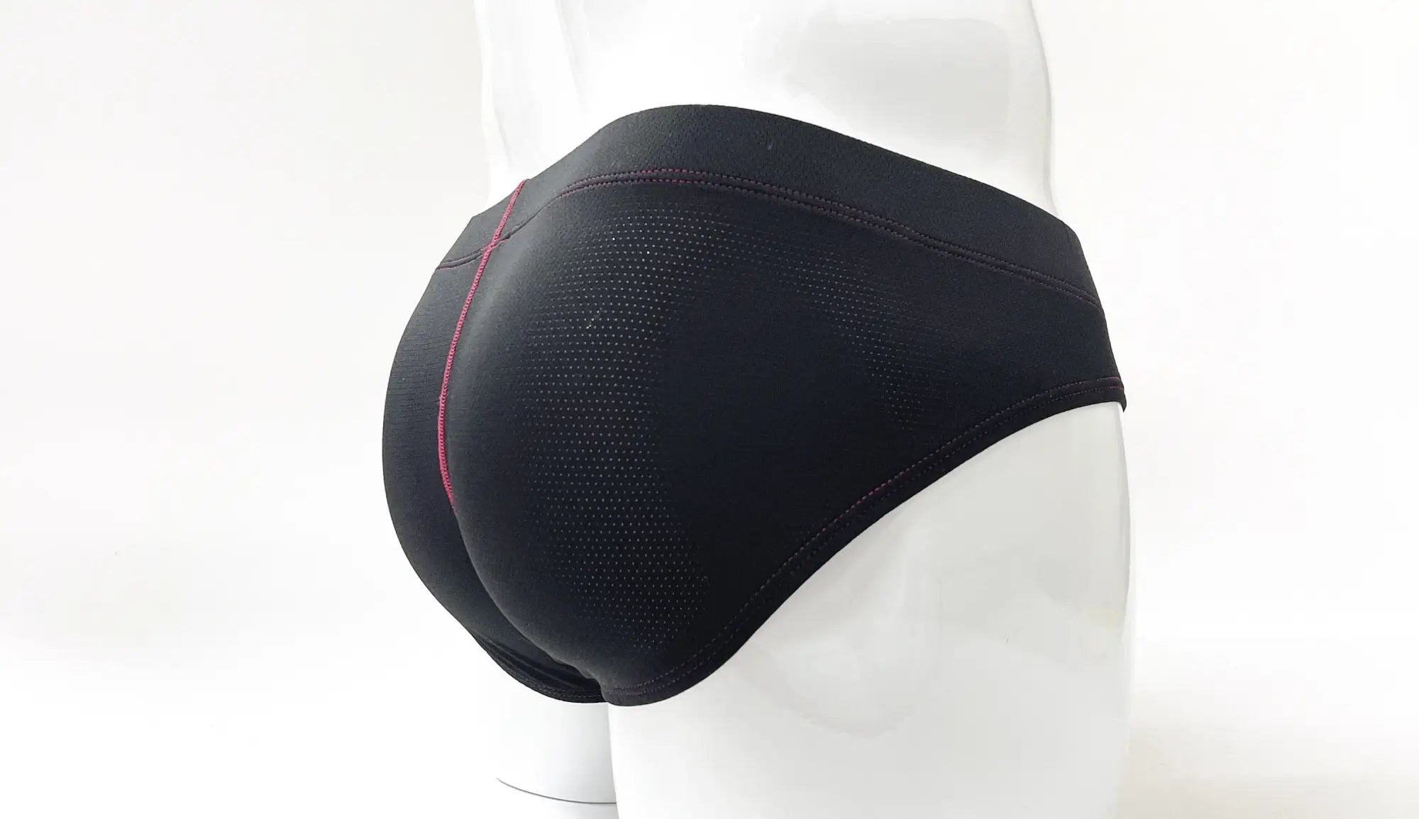 Wildmant stitch big boy pouch brief in black with subtle mesh texture and thin pink side seam for athletic wear