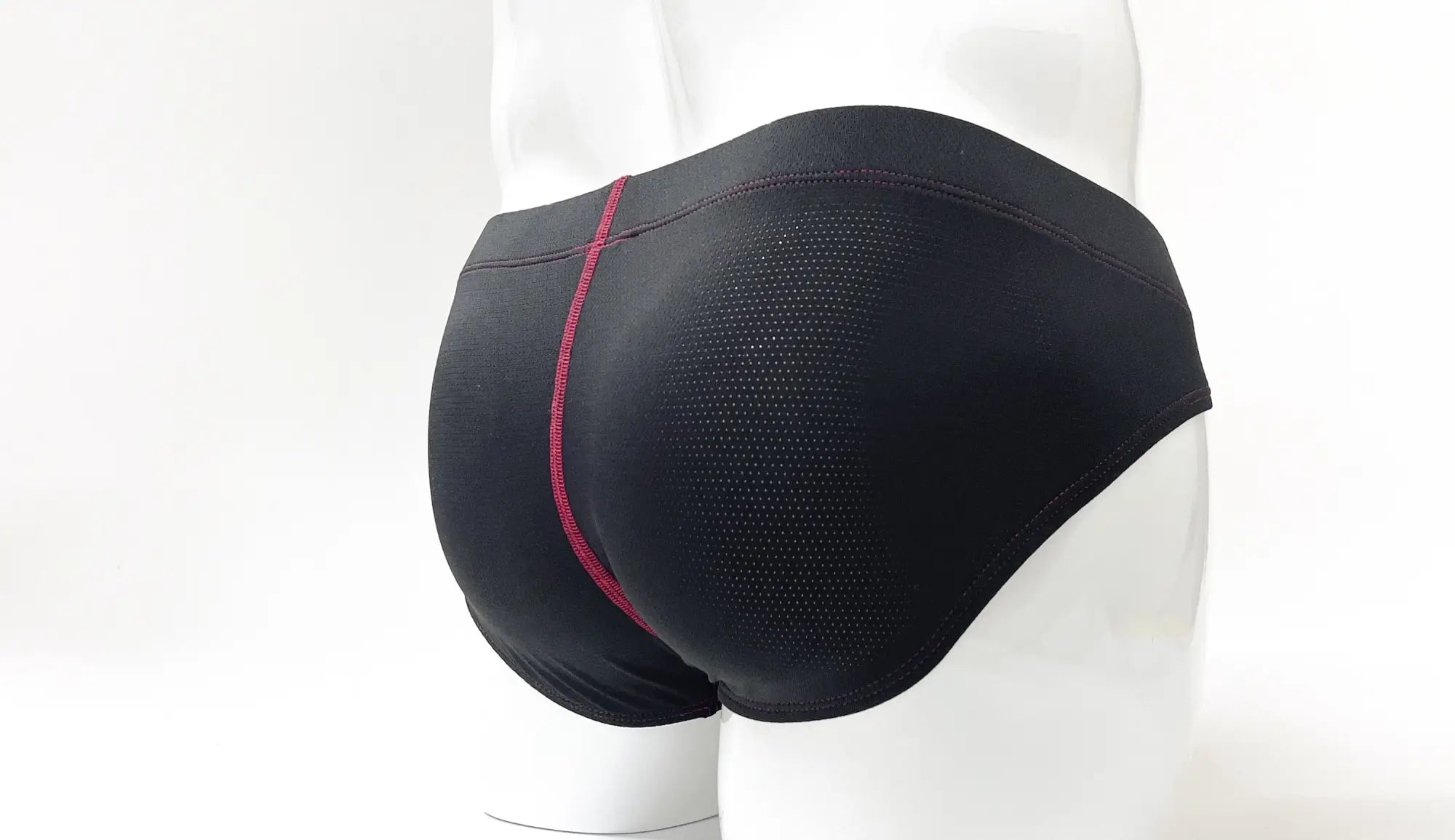 Wildmant stitch big boy pouch brief red in black athletic mesh fabric with a contrasting magenta side seam visible from front