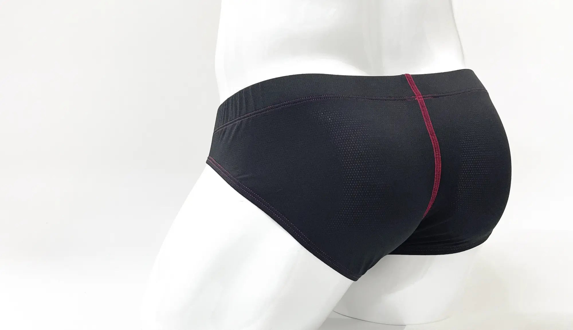 Black athletic WildmanT stitch big boy pouch brief with subtle textured pattern and red center seam stitching
