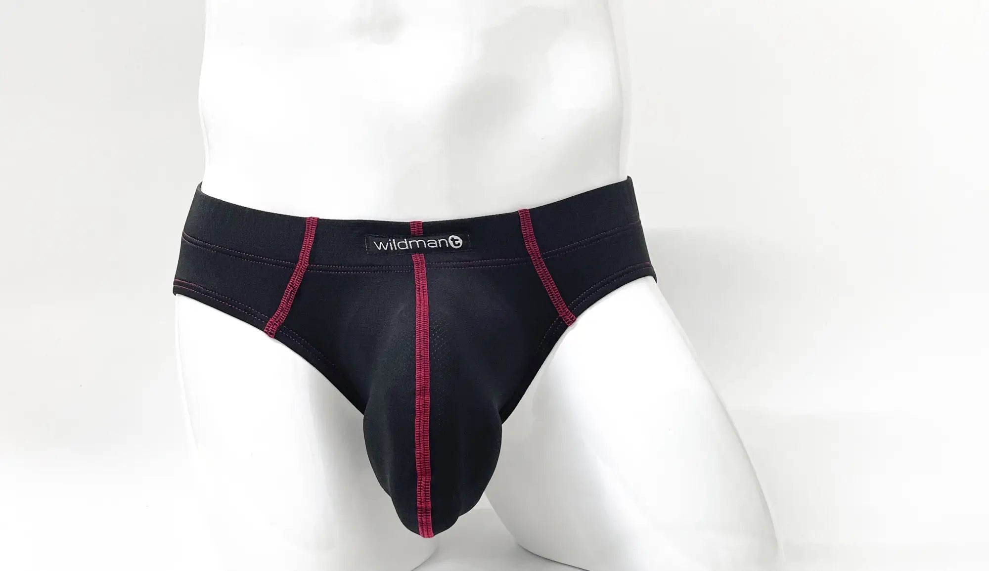 Black men’s briefs with red stitching and wildman brand label designed for comfort and support in wildmant stitch big boy
