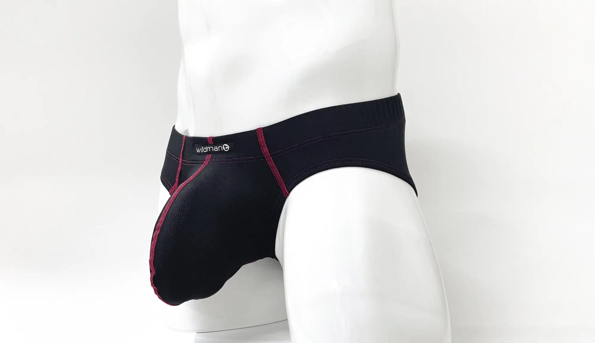 Black men’s briefs with red stitching and wildman logo waistband designed for comfort and support