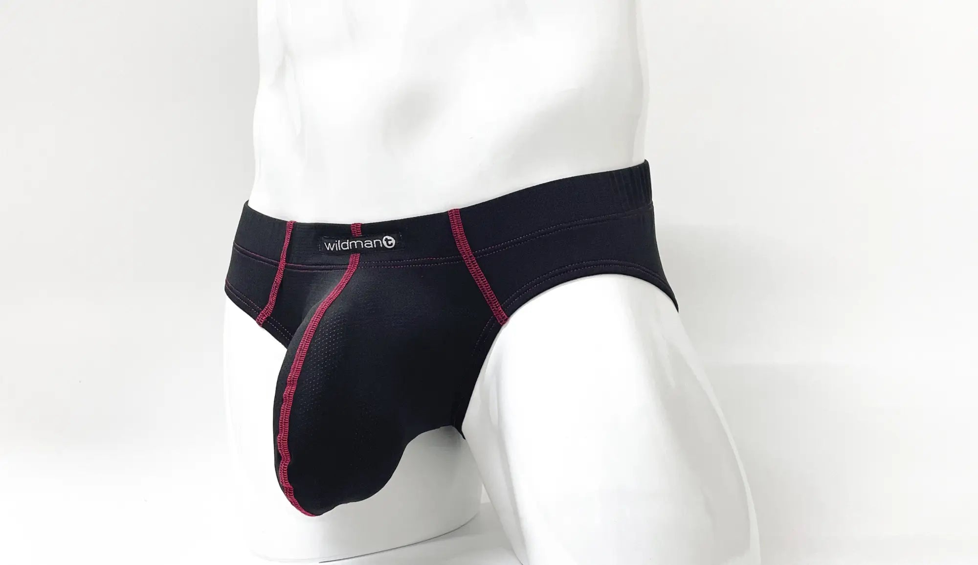 Black men’s briefs with red stitching and wildman logo on the waistband in wildmant stitch big boy pouch brief red