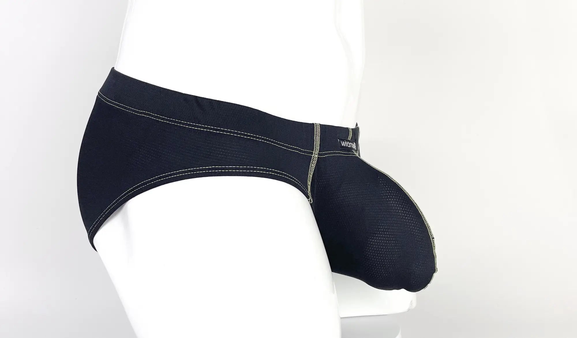 WildmanT Stitch big boy pouch brief in black mesh with white stitching and yellow brand logo on the waistband