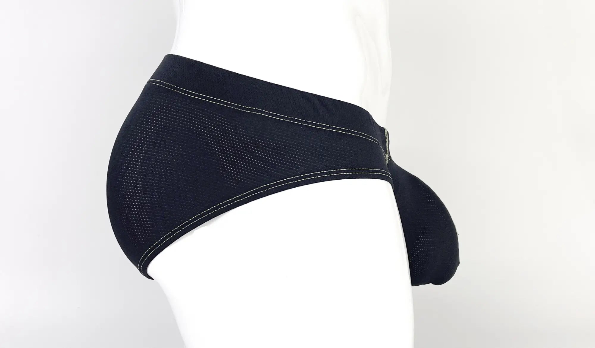 Wildmant stitch big boy pouch brief in yellow featuring black mesh material with white stitching and supportive pouch design