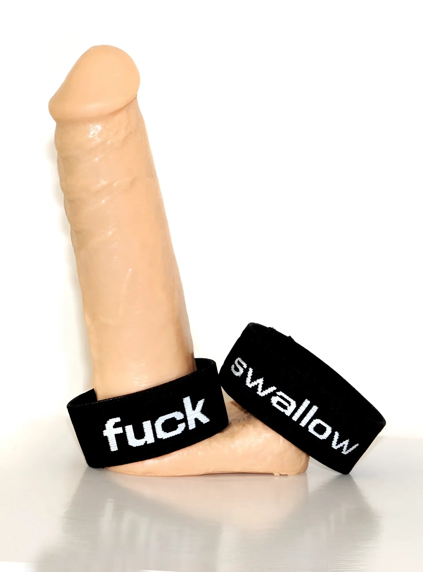 Beige silicone dildo with black wristbands featuring white text fuck and swallow in wildmant verbal max cock-ring fuck