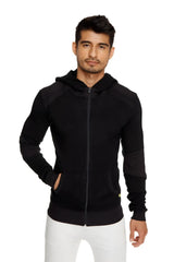 Black mid-weight luxury-fleece zip-up hoodie with dark shoulder panels and yellow hem tag for yoga and trackwear