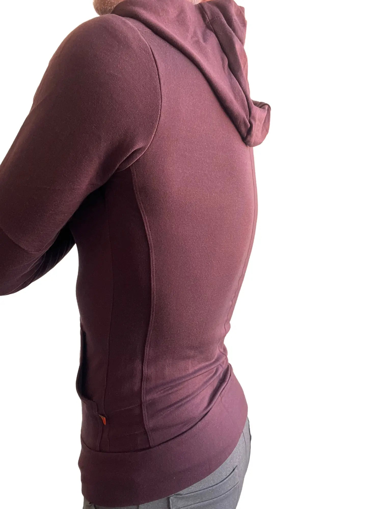A burgundy mid-weight luxury-fleece form-fit crossover yoga track hoodie with soft textured fabric and side seam detailing
