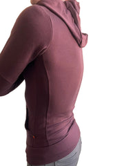 A burgundy mid-weight luxury-fleece form-fit crossover yoga track hoodie with soft textured fabric and side seam detailing