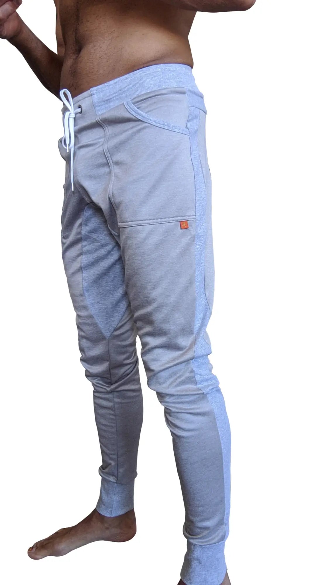 Light gray stainless steel grey winter edition performance-luxe-fleece joggers with white drawstrings and orange tag