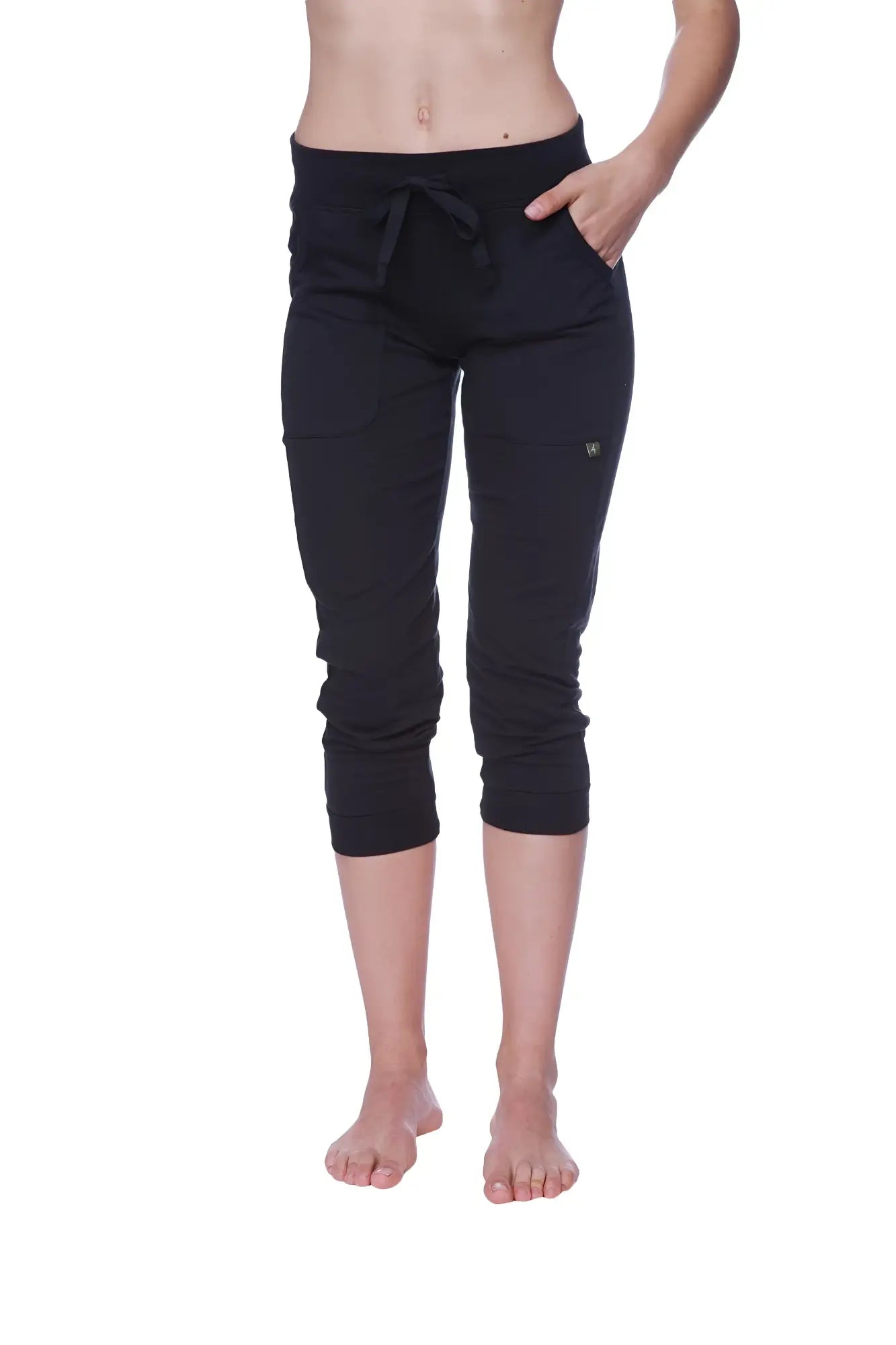 Women’s solid black capri yoga pant with cuffed hem drawstring waistband and side pockets in jogger style
