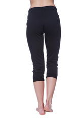 Black capri-length women’s yoga leggings with smooth stretchy fabric and elastic waistband in solid black