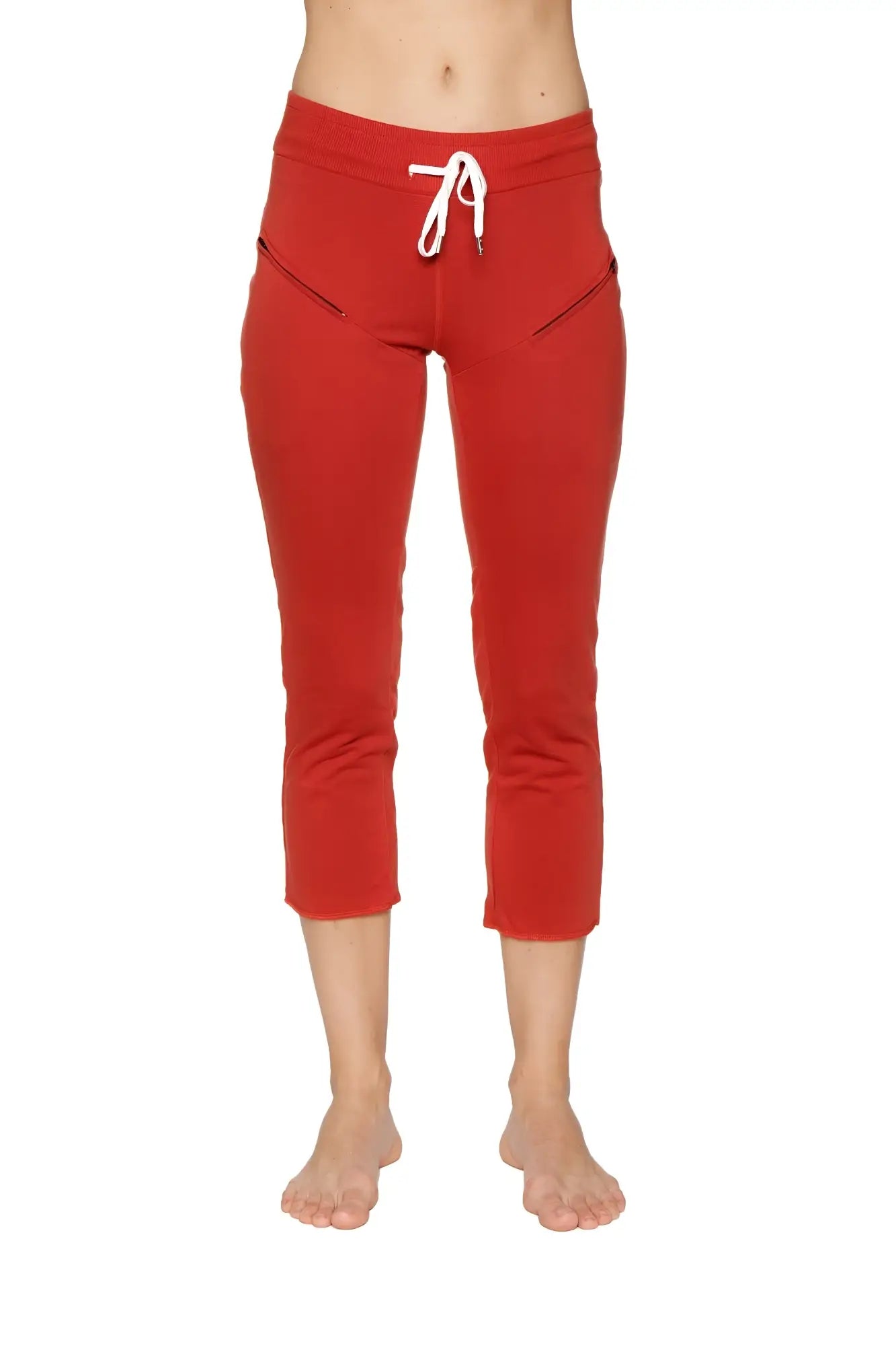 Women’s cinnabar red 4/5 length capri yoga pants with white drawstring waistband and diagonal zipper pockets