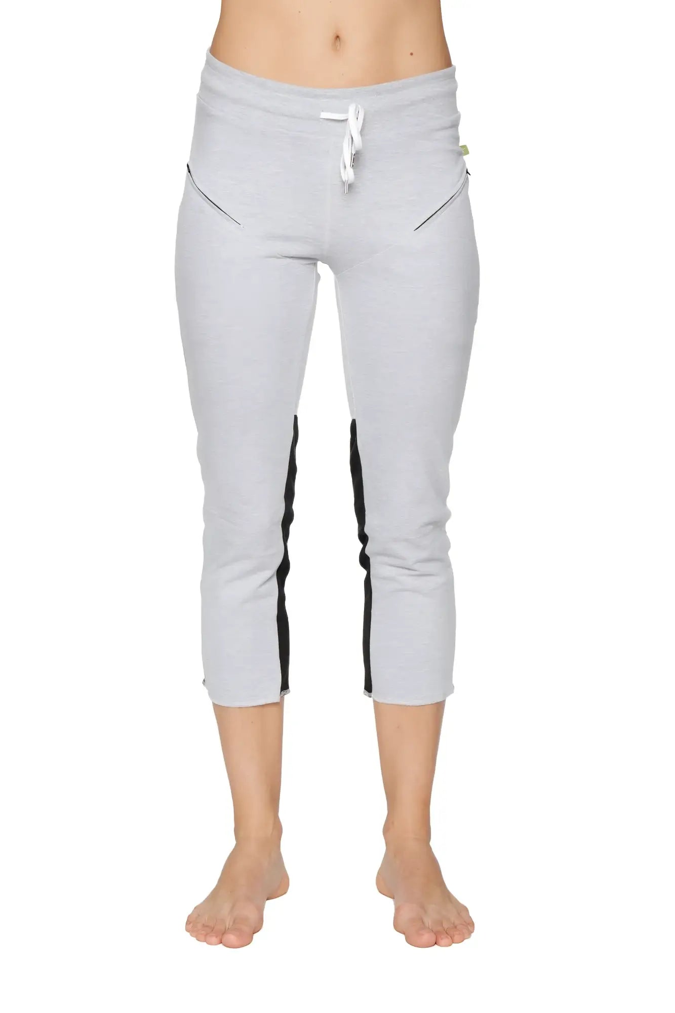 Women’s grey capri-length zipper pocket yoga pants with black side stripes and white drawstring waistband