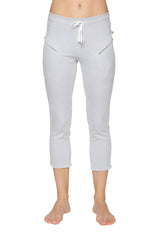 Light gray women’s 4/5 length capri yoga pant with white drawstring waistband and diagonal zipper pockets