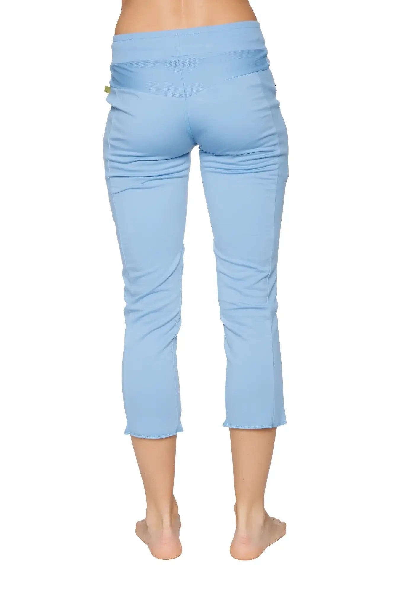 Women’s sky blue capri yoga pants with a high-waisted design, stretchy fabric, subtle side ruching, and zipper pockets