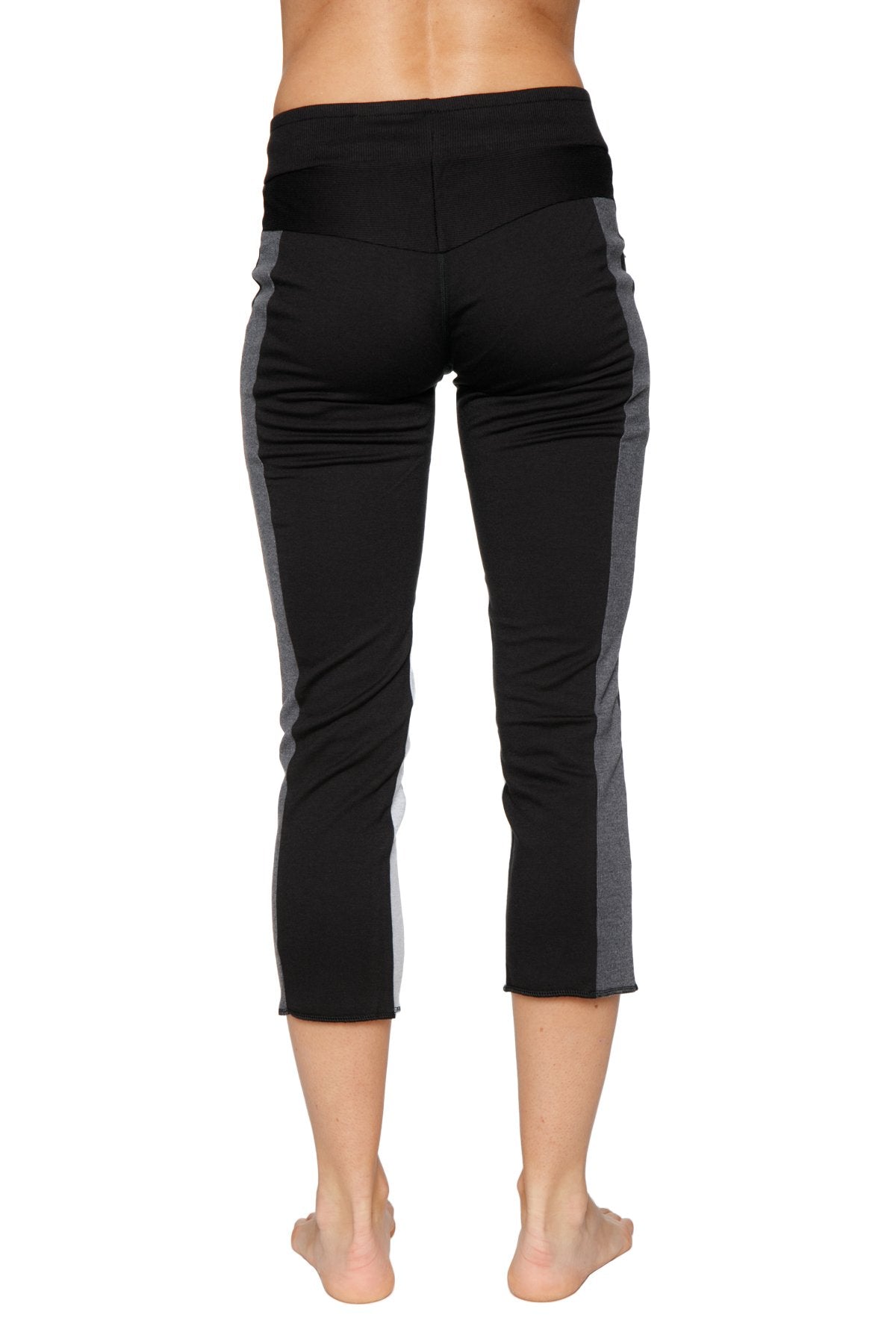 Women’s black and gray high-waisted 4/5 length zipper pocket capri yoga pants designed for athletic wear