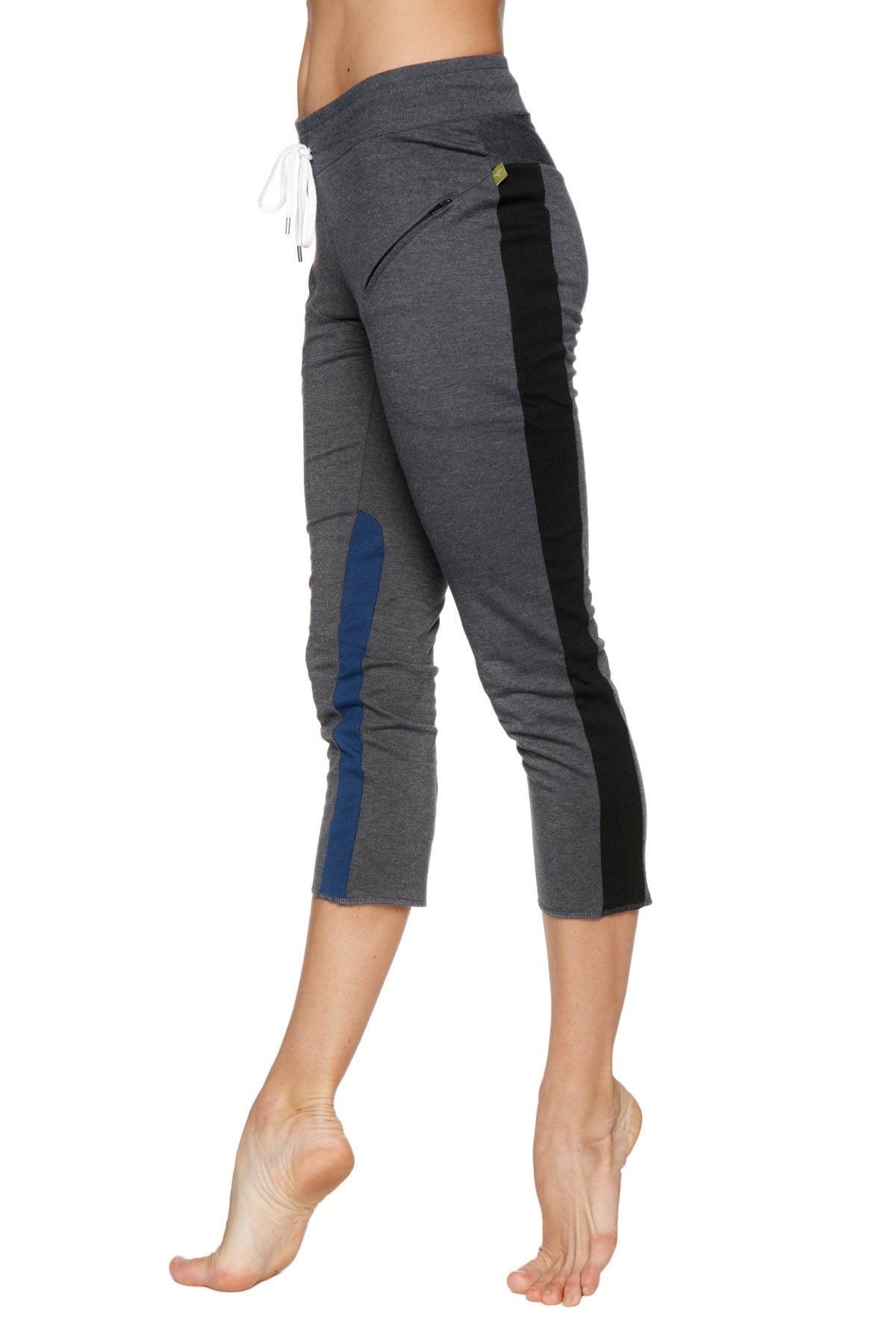 Women’s charcoal capri yoga pants with black and blue side panels, drawstring waist, zipper pockets, and yellow logo