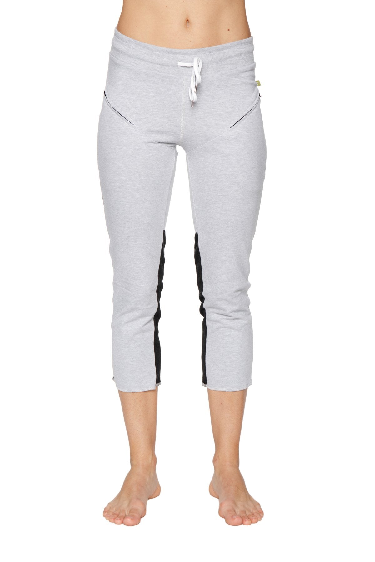 Women’s grey capri-length zipper pocket yoga pants with black side stripes and white drawstring waistband