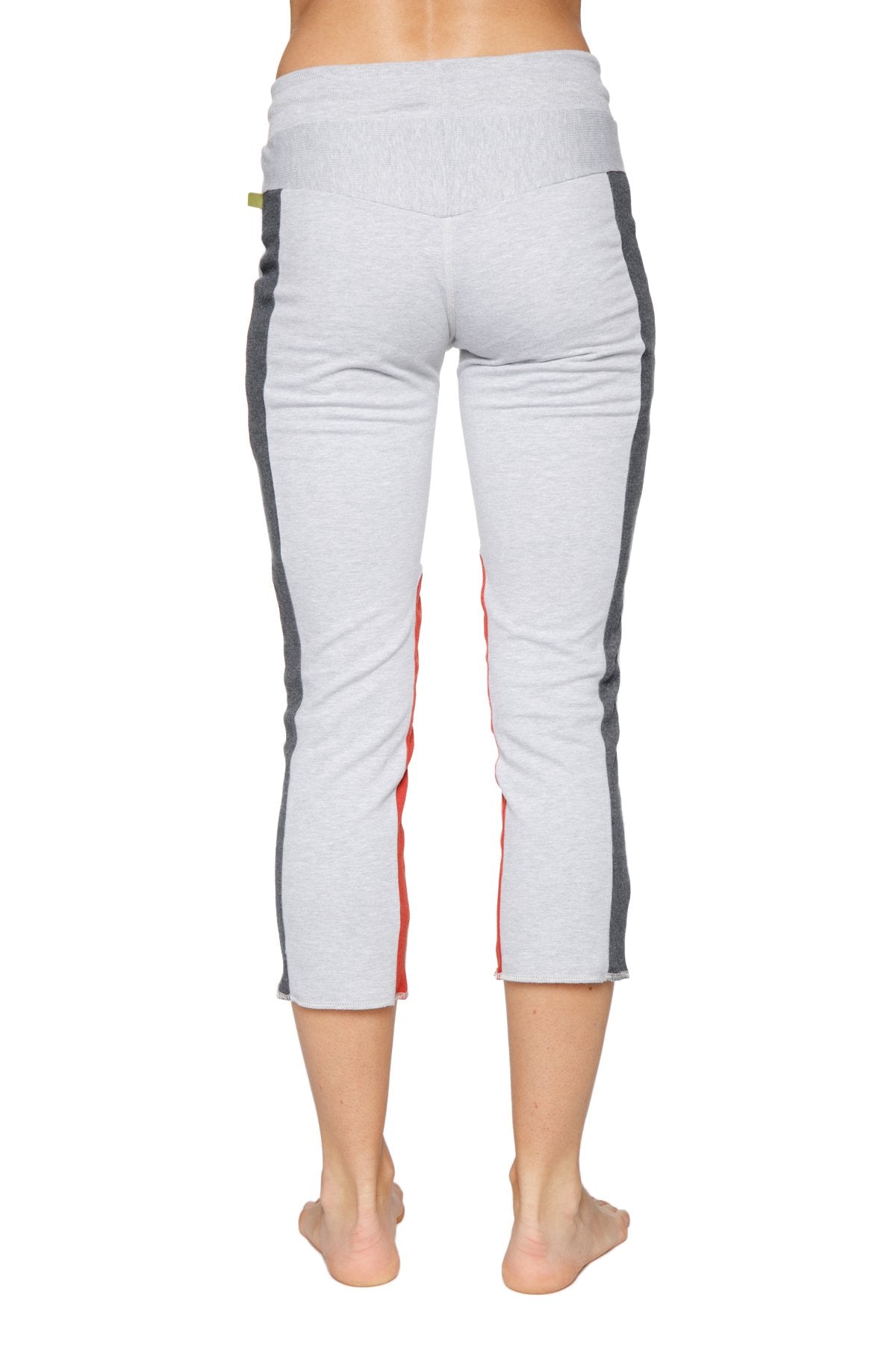 Women’s light gray capri-length yoga leggings with dark gray and red side stripes and zipper pocket for active wear