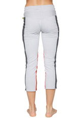 Women’s light gray capri-length yoga leggings with dark gray and red side stripes and zipper pocket for active wear