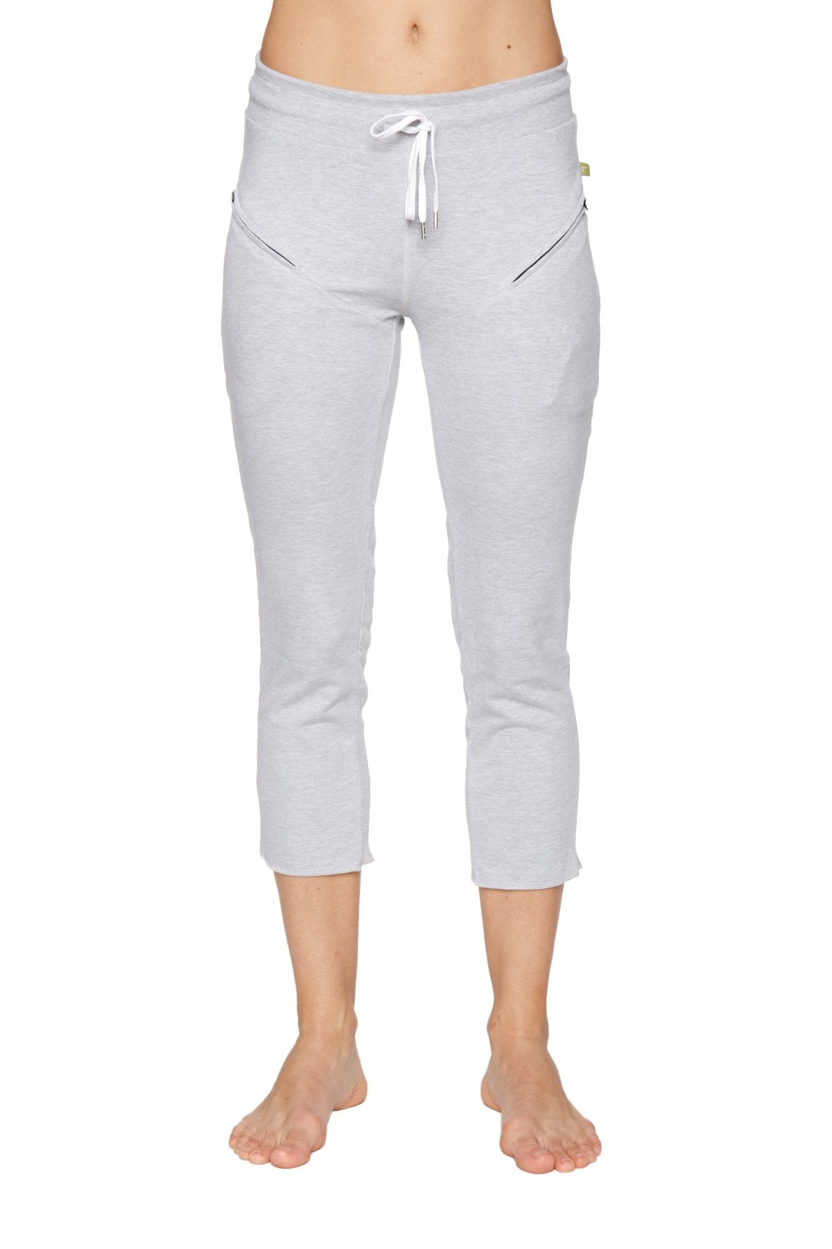 Light gray women’s 4/5 length capri yoga pant with white drawstring waistband and diagonal zipper pockets