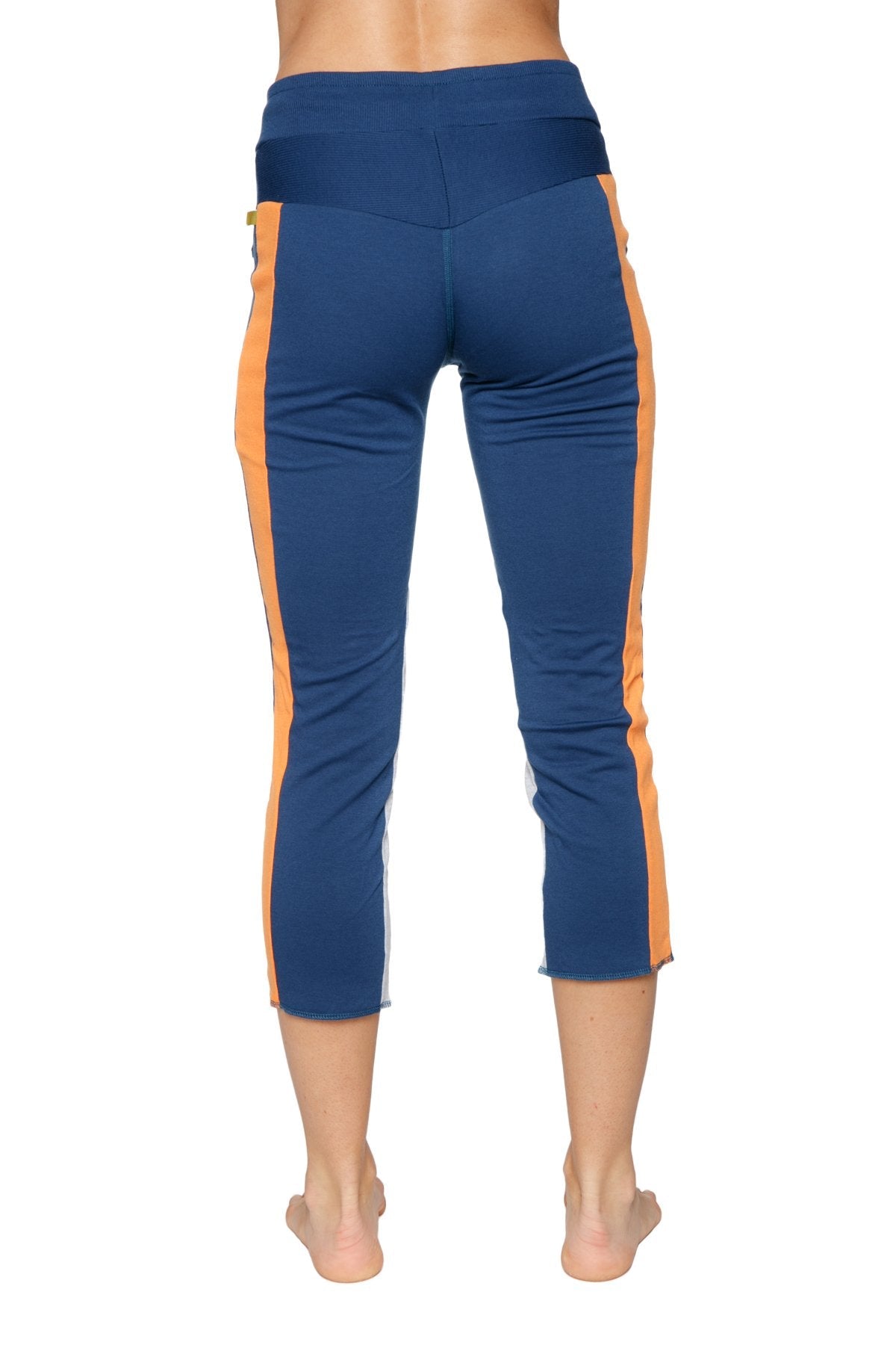 Women’s 4/5 length zip pocket capri yoga pants in royal blue with orange and grey high-waisted athletic design