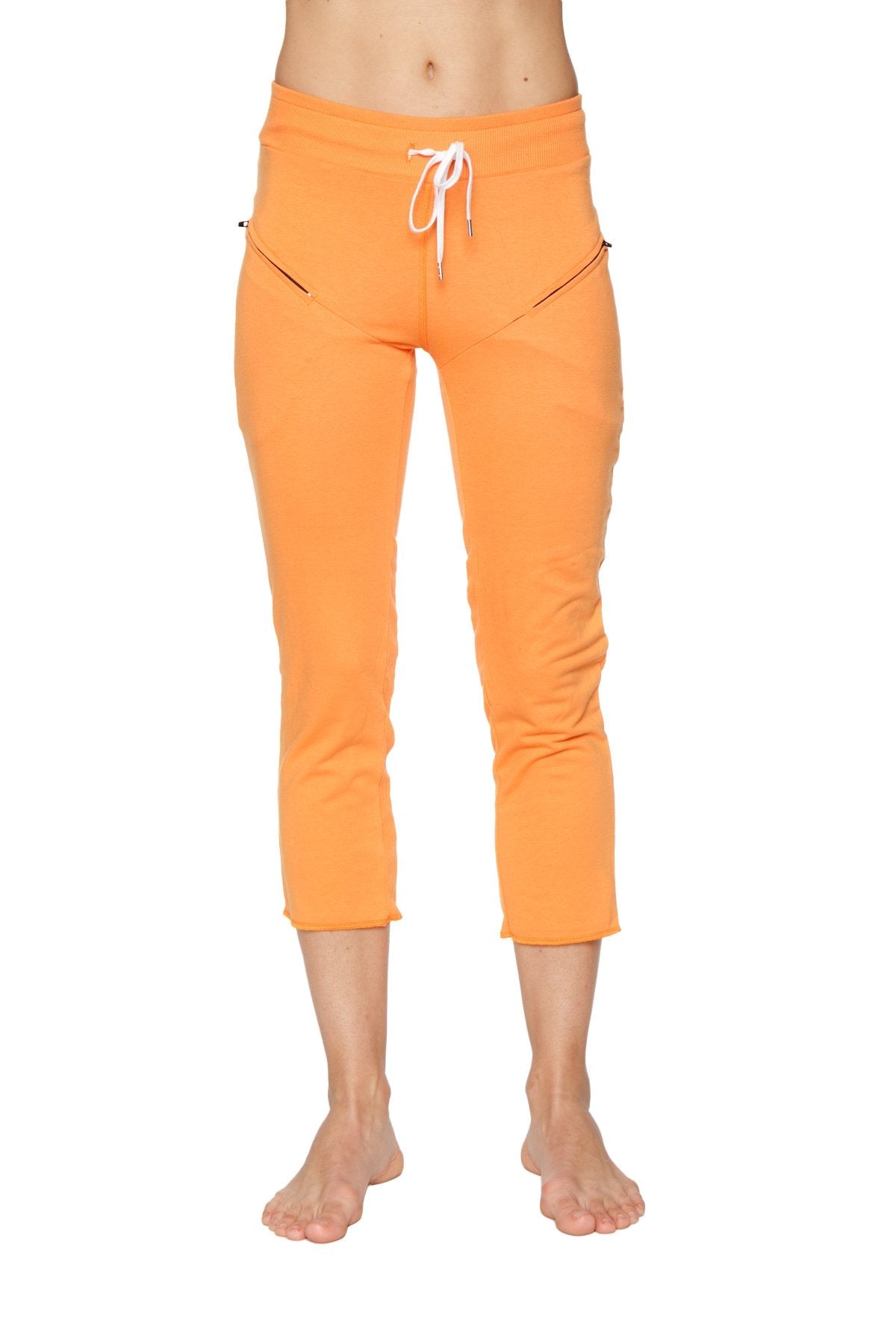 Women’s sun orange capri yoga pant with white drawstring waistband and side zipper pockets in 4/5 length