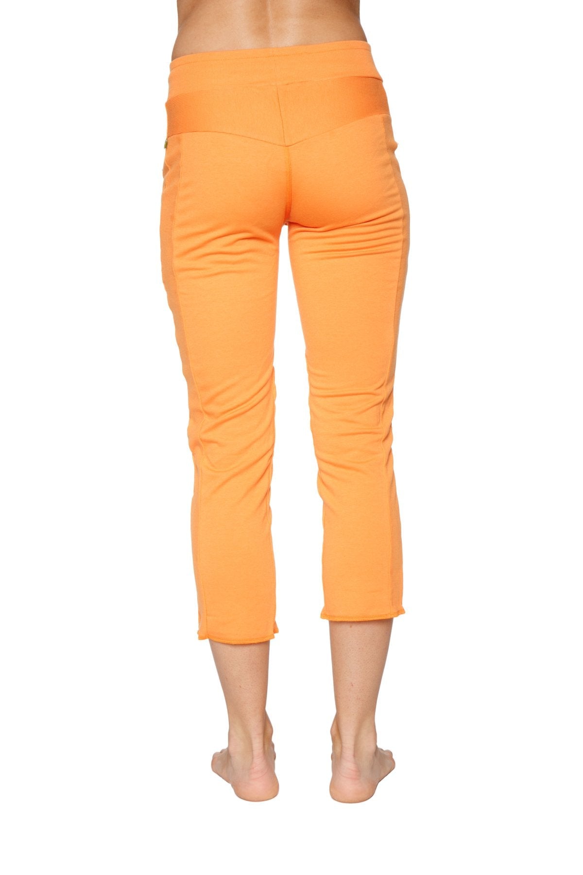 Women’s sun orange 4/5 length capri yoga pants with high-waisted elastic band and subtle vertical seam detailing