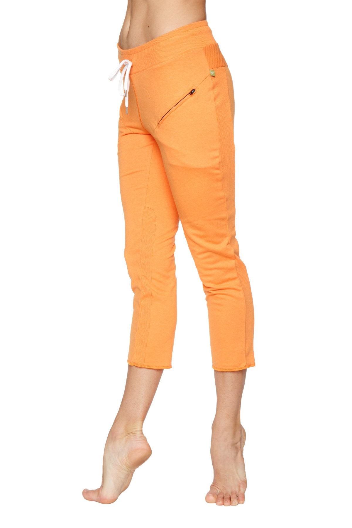 Women’s sun orange 4/5 length capri yoga pants with white drawstring waistband and side zippered pocket
