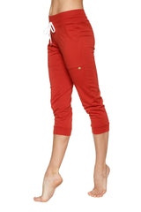 Women’s red cuffed capri-length jogger yoga pants with white drawstring waistband and elastic cuffs in cinnabar color