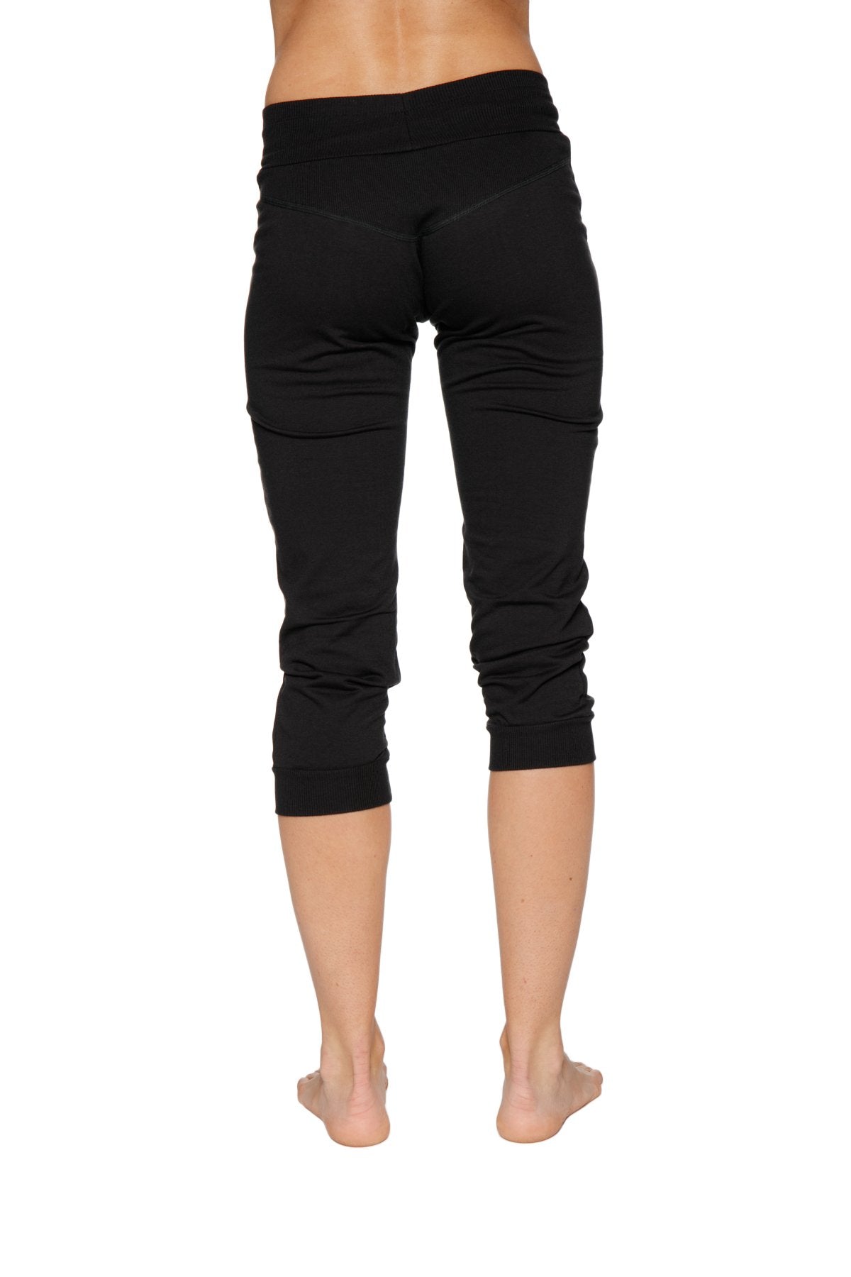 Women’s cuffed jogger yoga pant in solid black with soft stretchy fabric and elastic waistband in capri length